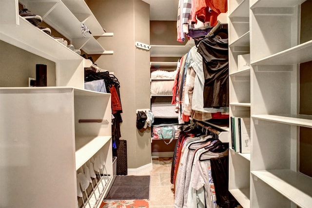 spacious closet featuring light tile floors