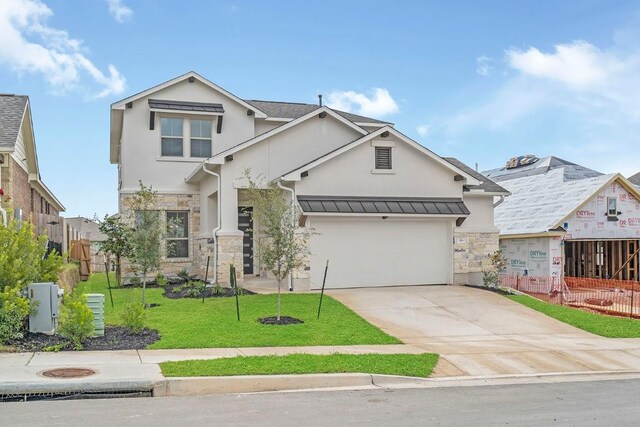 view of front of home with a garage and a front lawn