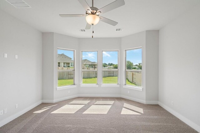 carpeted empty room featuring ceiling fan