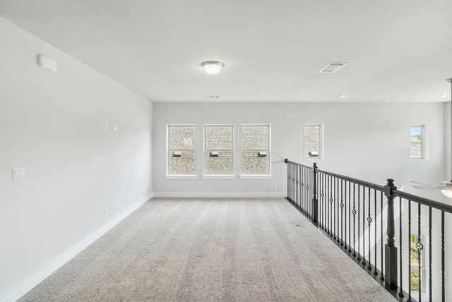 empty room with light carpet and ceiling fan