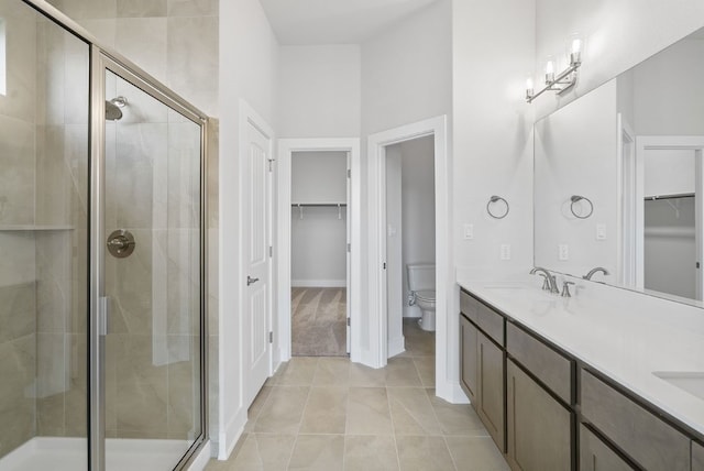 bathroom with vanity, toilet, and an enclosed shower