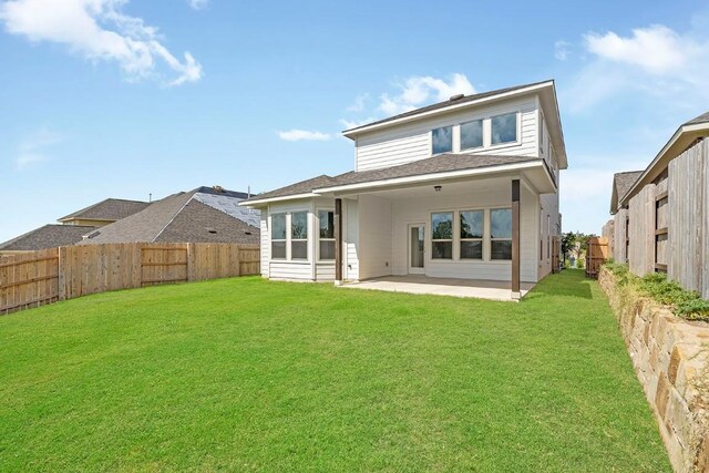 back of property with a patio area and a lawn