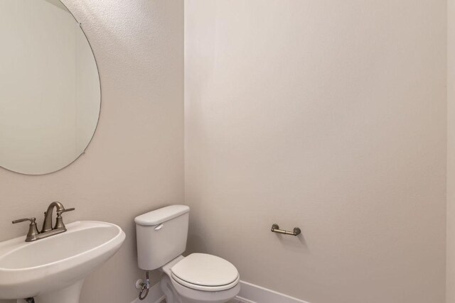 316 Chaste Tree Dr, San Marcos, TX 78666 - half bathroom with a sink, baseboards, and toilet