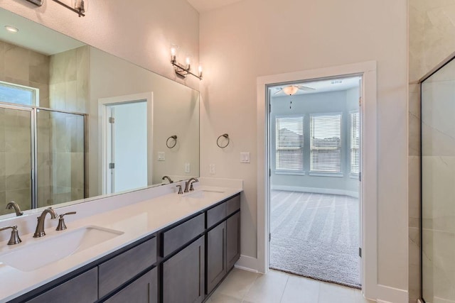 316 Chaste Tree Dr, San Marcos, TX 78666 - bathroom featuring double vanity, tile patterned floors, a stall shower, and baseboards