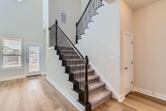 316 Chaste Tree Dr, San Marcos, TX 78666 - stairway with wood finished floors, a towering ceiling, and baseboards