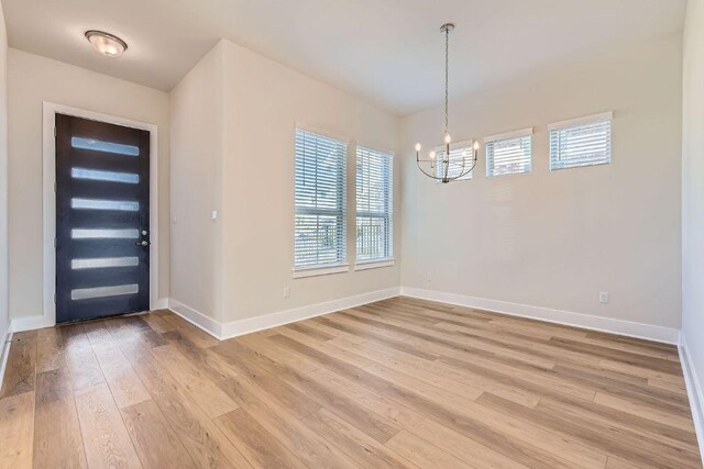 316 Chaste Tree Dr, San Marcos, TX 78666 - entrance foyer featuring a chandelier, light wood-type flooring, and baseboards