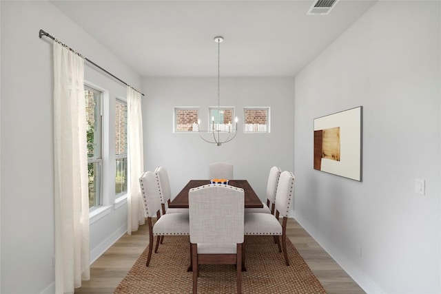 316 Chaste Tree Dr, San Marcos, TX 78666 - dining area with a chandelier, plenty of natural light, light wood-style floors, and baseboards