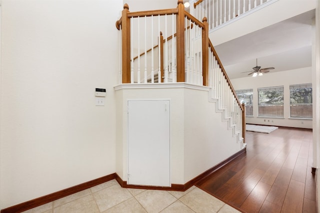 stairway featuring ceiling fan and hardwood / wood-style floors