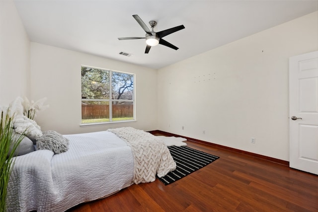 bedroom with ceiling fan and dark wood-type flooring