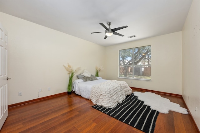 bedroom featuring ceiling fan and dark hardwood / wood-style flooring