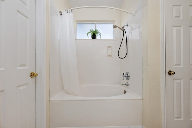 bathroom featuring shower / tub combo with curtain