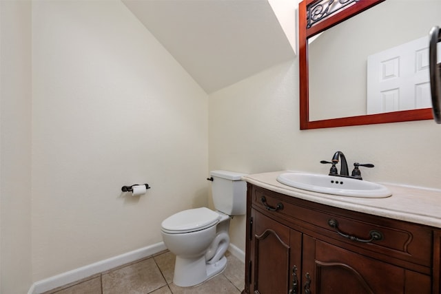 bathroom with tile patterned floors, vanity, lofted ceiling, and toilet