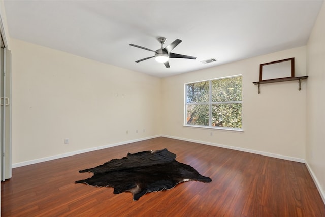 spare room with ceiling fan and wood-type flooring