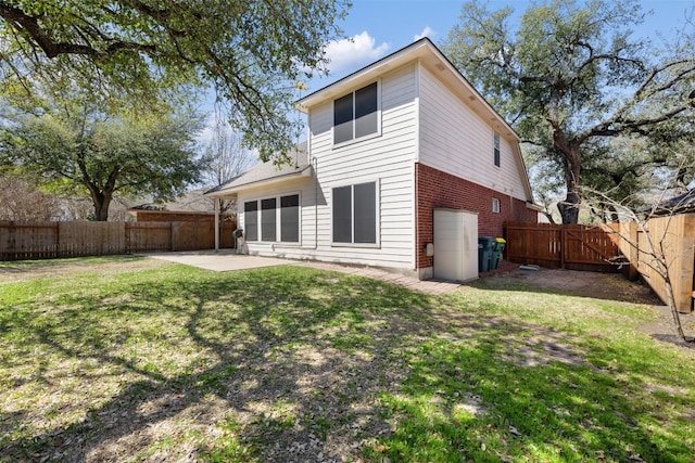 rear view of house with a patio and a lawn