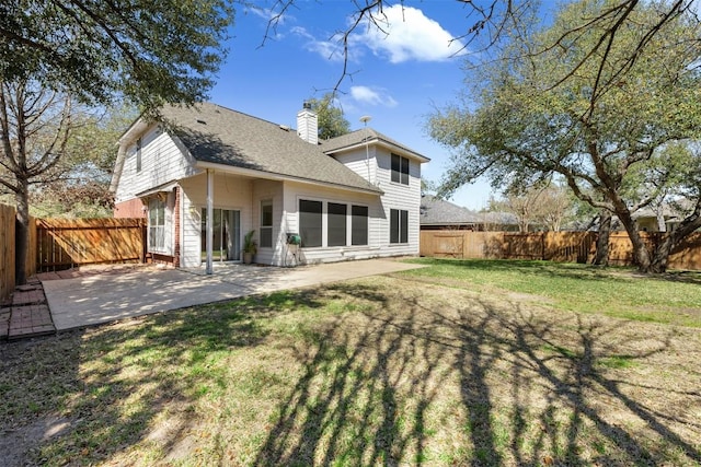 rear view of house with a yard and a patio area