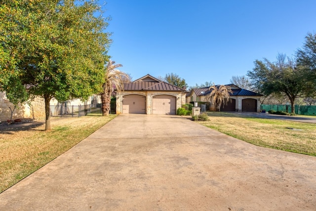 mediterranean / spanish-style home featuring a garage and a front yard