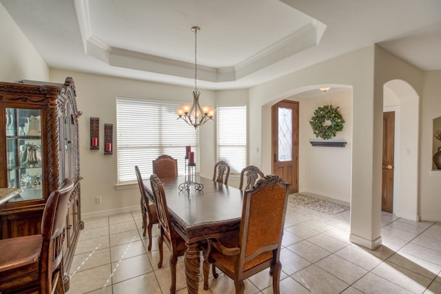 dining room featuring a tray ceiling, light tile patterned floors, and a chandelier