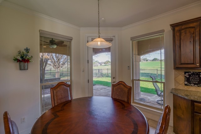 dining space featuring ceiling fan and ornamental molding