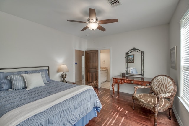 bedroom with ensuite bath, ceiling fan, and dark wood-type flooring