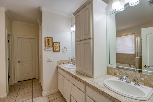 bathroom featuring tile patterned floors, vanity, ornamental molding, and a tub to relax in