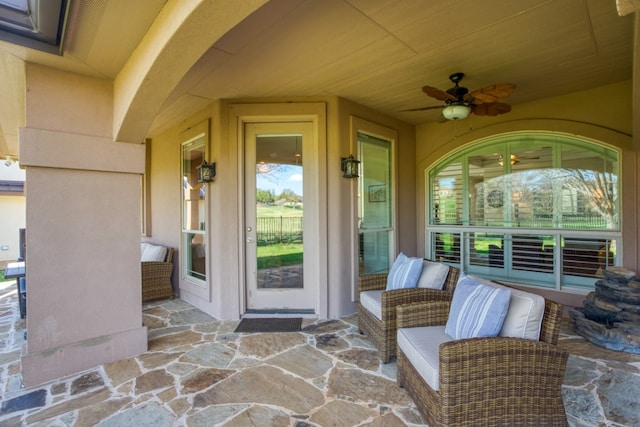 view of exterior entry featuring ceiling fan