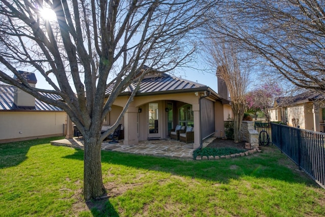 back of house featuring a patio area, an outdoor living space, and a yard