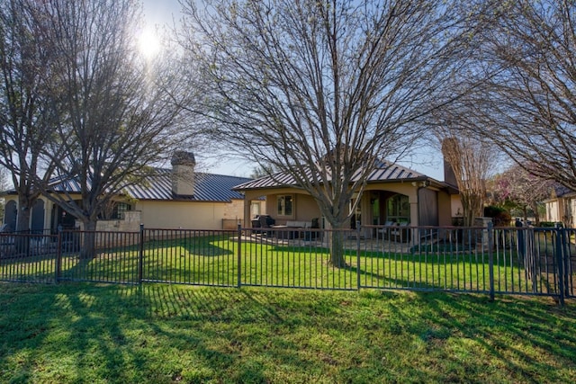 back of house featuring a lawn