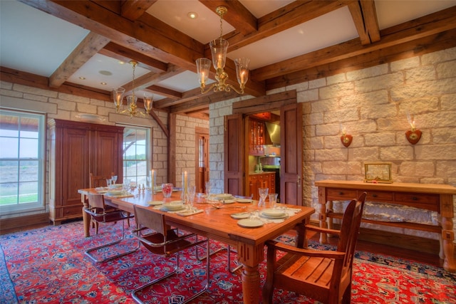 dining space featuring a notable chandelier and beamed ceiling