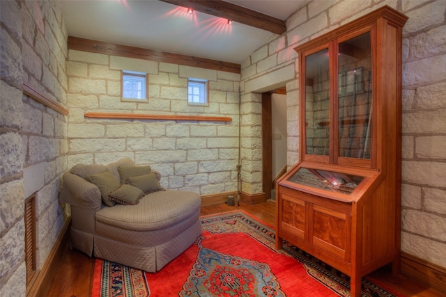 living area with dark hardwood / wood-style floors and beamed ceiling