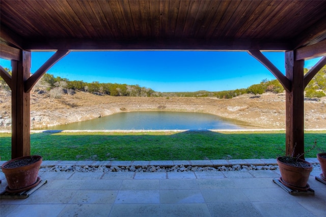 view of yard with a patio and a water view