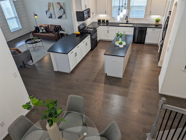 living room featuring a wealth of natural light, dark wood-type flooring, and sink