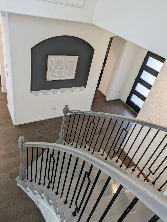 staircase featuring dark hardwood / wood-style flooring