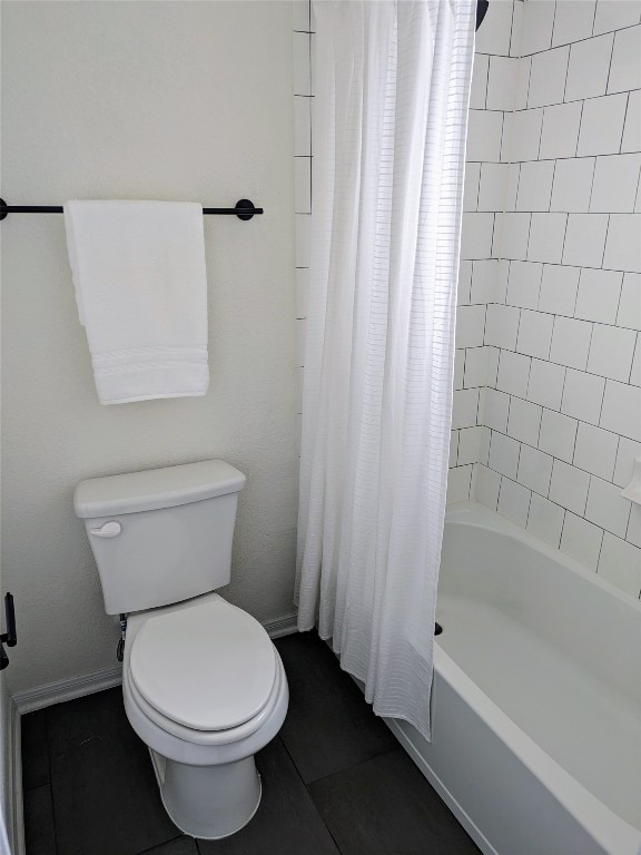 bathroom featuring toilet, shower / tub combo, and tile floors