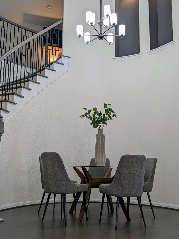 dining room featuring dark hardwood / wood-style floors and an inviting chandelier