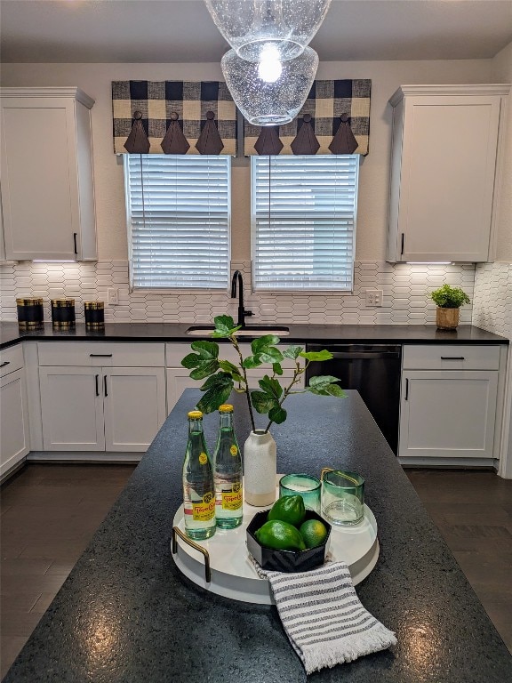 kitchen with tasteful backsplash, white cabinetry, and dark hardwood / wood-style flooring