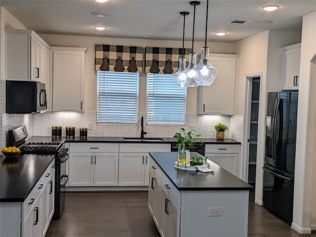 kitchen with dark hardwood / wood-style floors, backsplash, black appliances, and sink