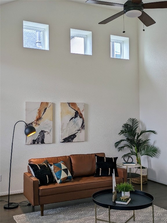 living room featuring ceiling fan and dark wood-type flooring