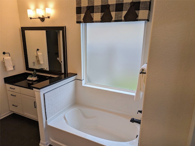 bathroom featuring a bathtub and large vanity