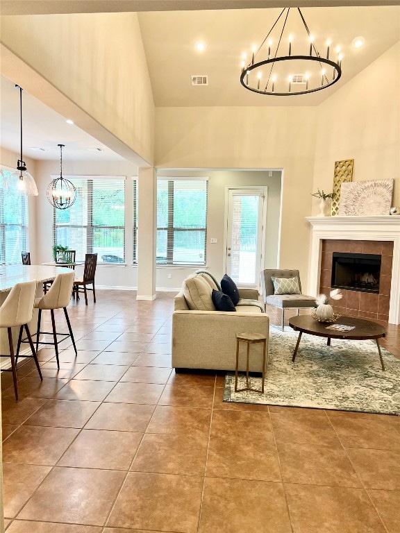 tiled living room featuring high vaulted ceiling and a fireplace