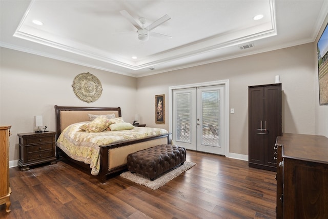 bedroom with dark wood-type flooring, ceiling fan, a tray ceiling, and french doors