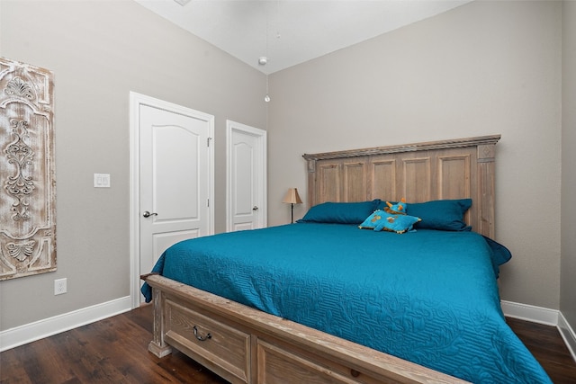 bedroom featuring lofted ceiling and dark hardwood / wood-style flooring