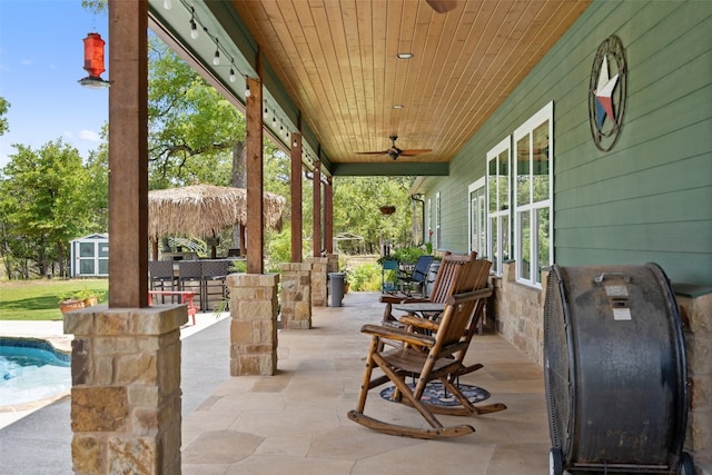 view of patio / terrace with an outdoor structure and ceiling fan