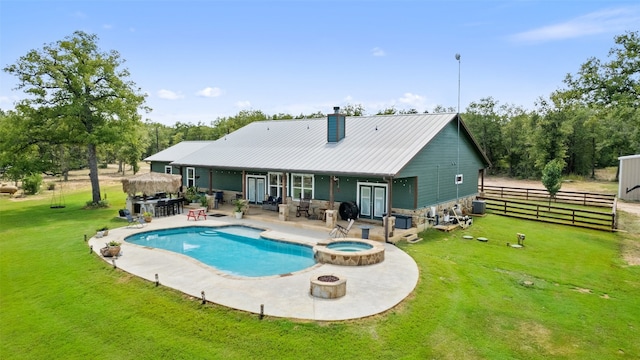 view of swimming pool with a patio area, an in ground hot tub, a lawn, and central AC unit