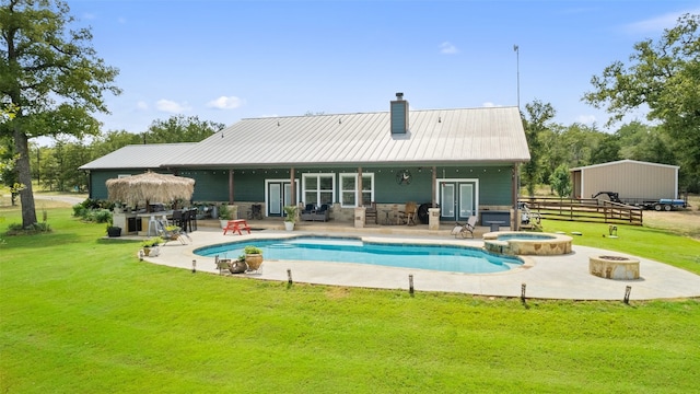 exterior space featuring a patio area, an in ground hot tub, and a lawn