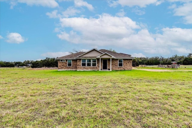 view of front of property featuring a front yard and a rural view