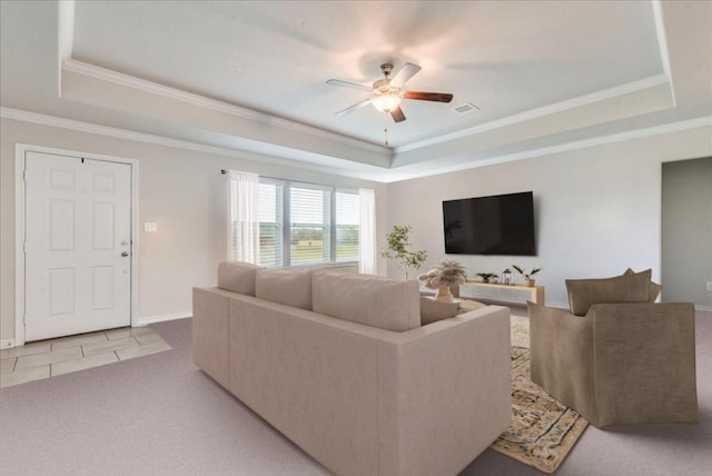 tiled living room featuring ornamental molding, ceiling fan, and a tray ceiling