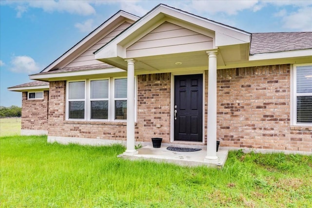 view of exterior entry with a porch