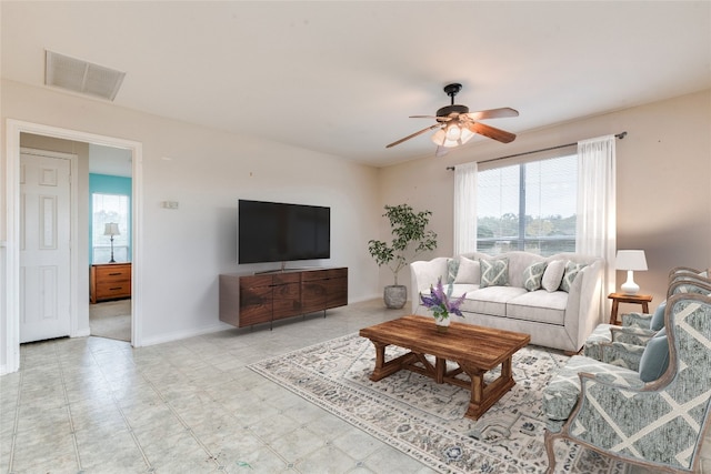 living room with ceiling fan and plenty of natural light