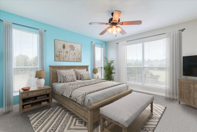 carpeted bedroom featuring ceiling fan and multiple windows