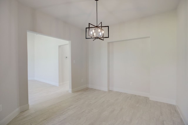 117 Callie St, Smithville, TX 78957 - unfurnished dining area with light wood-style flooring, a chandelier, and baseboards